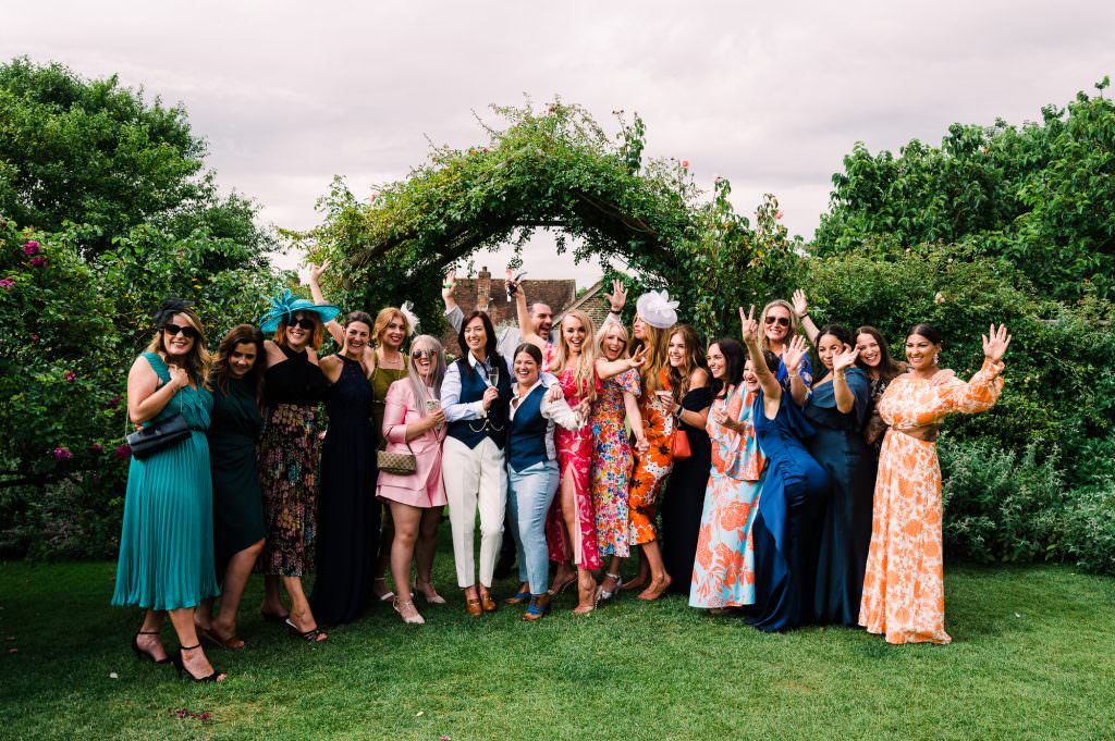 Group photo of wedding guests in the gardens at Pangdean Old Barn
