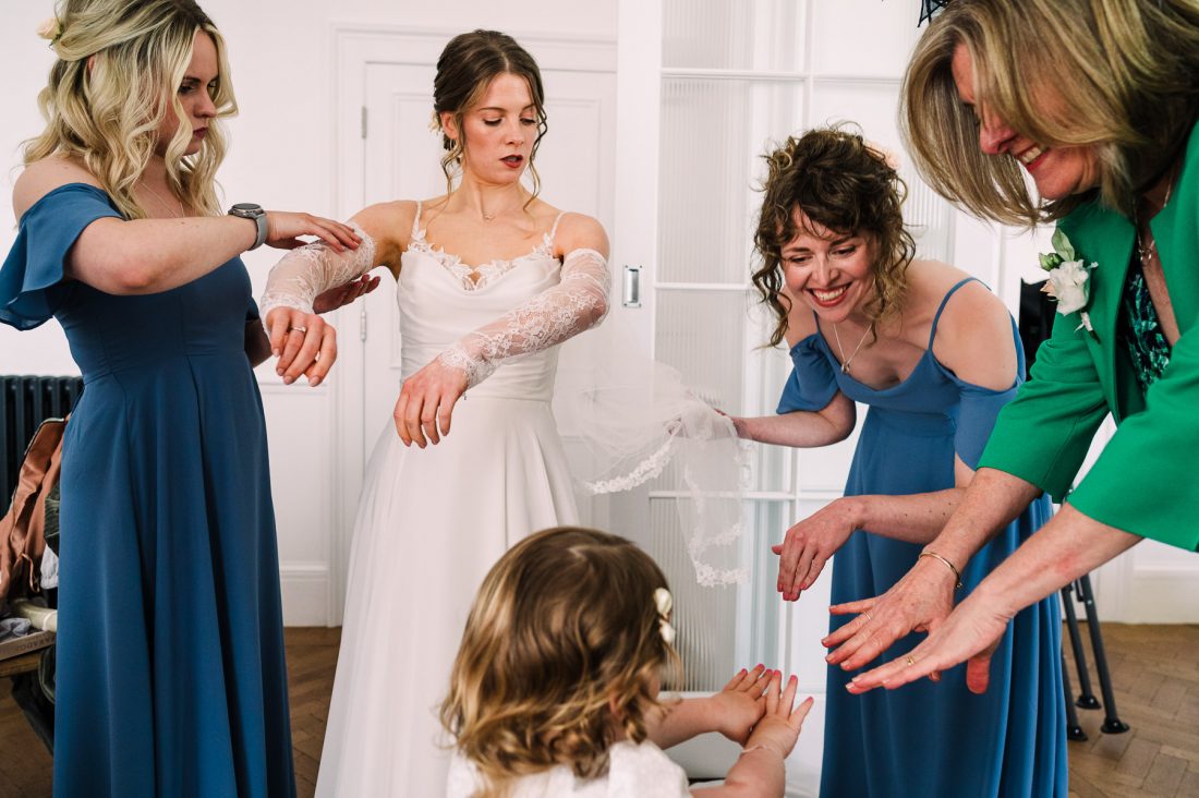 Bridesmaids and flower girl compare nails while getting ready for a Tunnels Beaches wedding
