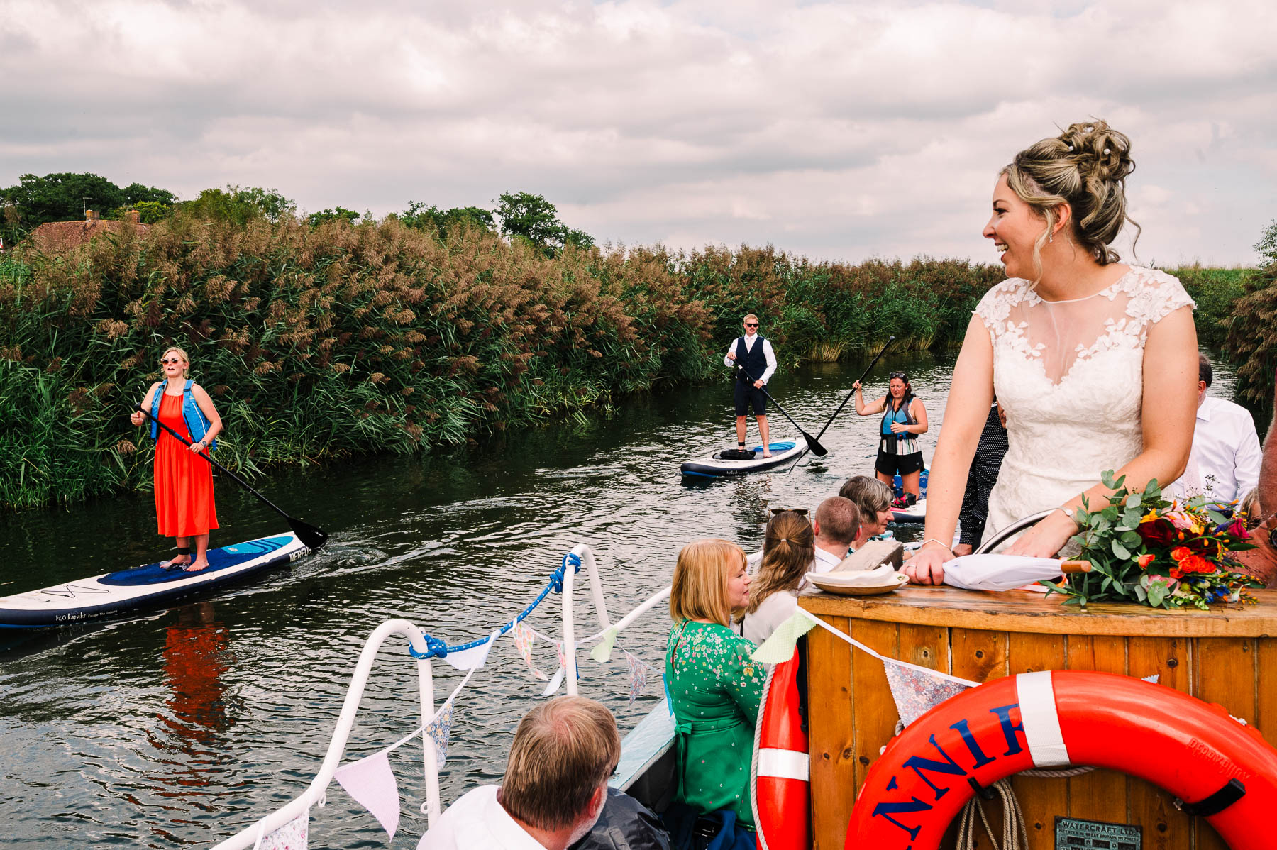 Bride on a river boat enjoying her Sussex wedding reception