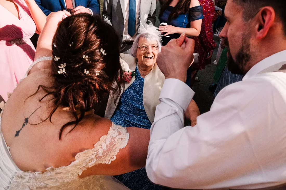 Bride's gran enjoying the dancefloor in a wheelchair at Long Furlong Barn wedding