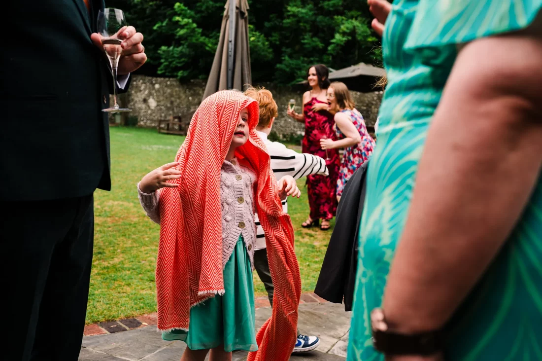 Candid photo of girl wearing scarf on her head at Cissbury Barns wedding