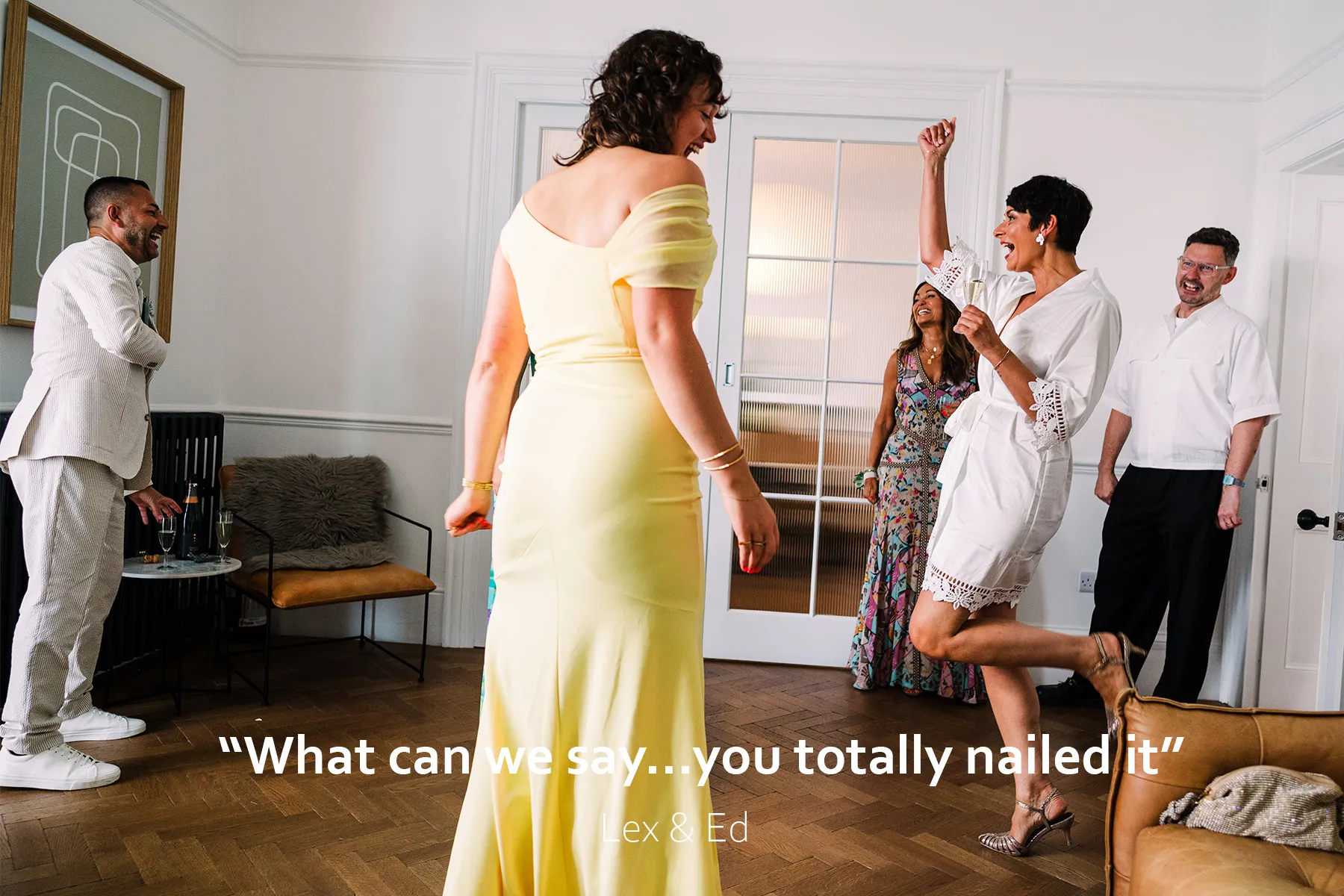 Bride dances with joy in her wedding shoes and dressing gown during her preparations for her Tunnels Beaches wedding