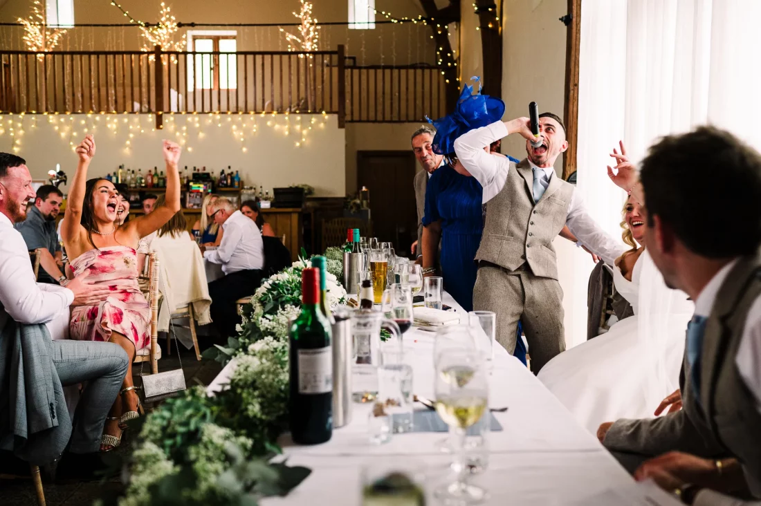 Groom sings during speeches at Long Furlong Barn wedding