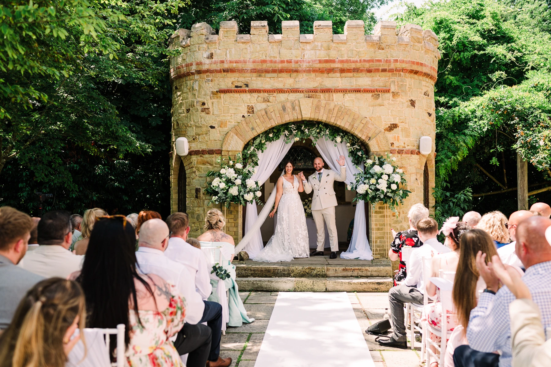 Newly-wed couple punch the air during their wedding ceremony at The Ravenswood